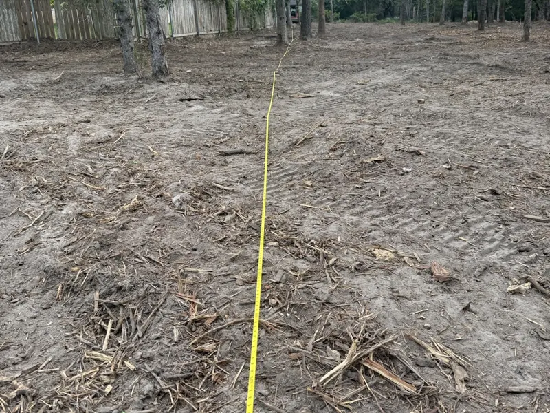Platted lot after mulching, tape pulled to check the line, oaks kept