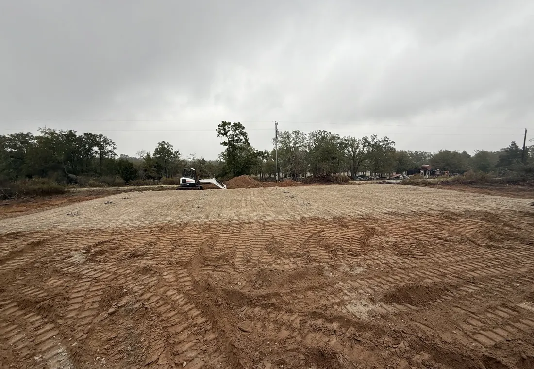 A graded building pad roughed in on a cleared homesite